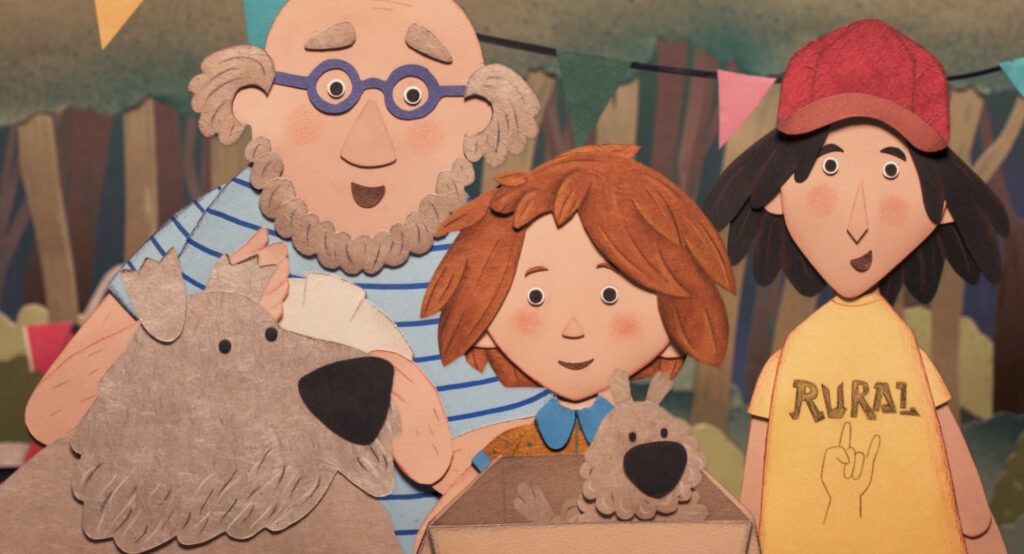 Scherenschnittfiguren aus dem Film "Die Schatzsuche im Blaumeisental": Ein Mann mit Brille, zwei Kinder und zwei Hunde schauen dich fröhlich an.